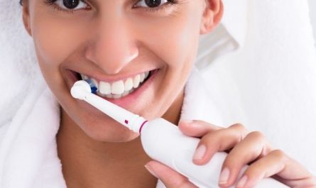 brush teeth with an electric toothbrush