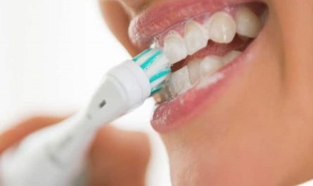 brushing teeth with electric toothbrush